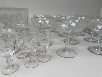 A set of glassware featuring engraved, stylized...