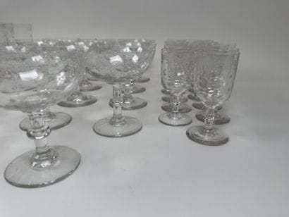 A set of glassware featuring engraved, stylized...