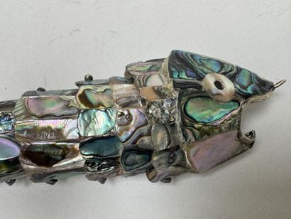 Articulated fish-shaped bottle opener made...