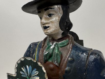 Polychrome cast-iron clock depicting a peddler.
H....