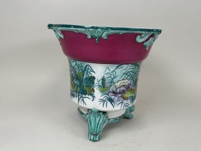Large polychrome ceramic planter with a foliage...