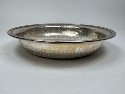 A circular, deep dish made of silver plated...