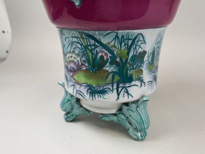 Large polychrome ceramic planter with a foliage...