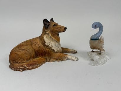A hardstone swan resting on a piece of white...