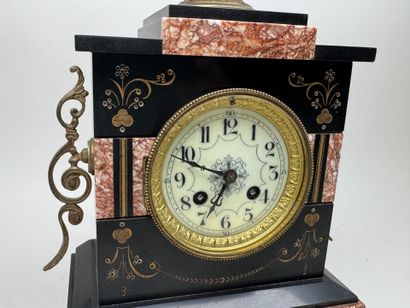 Black marble clock with a circular dial featuring...