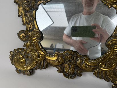 A repoussé brass panel decorated with acanthus...