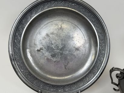 An 11-piece pewter set including a plate,...