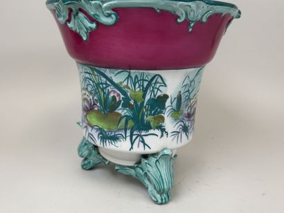 Large polychrome ceramic planter with a foliage...