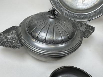 An 11-piece pewter set including a plate,...