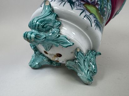 Large polychrome ceramic planter with a foliage...