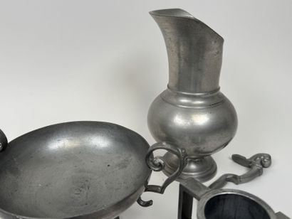 An 11-piece pewter set including a plate,...