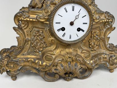 A pendulum clock with a golden patina, depicting...