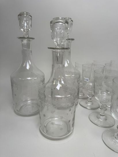 A set of glassware featuring engraved, stylized...