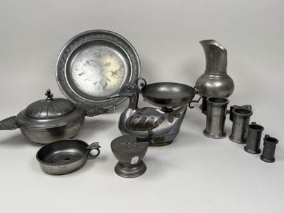 An 11-piece pewter set including a plate,...