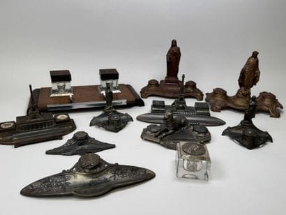 A collection of 11 desk inkwells with pen...
