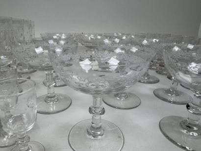 A set of glassware featuring engraved, stylized...