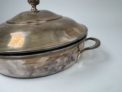 A large, silver plated metal-covered vegetable...