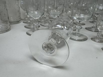 A set of glassware featuring engraved, stylized...