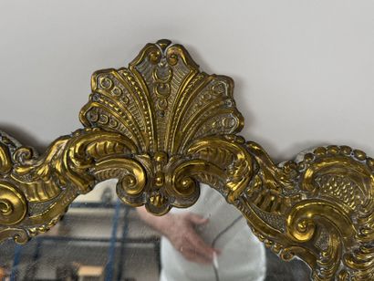 A repoussé brass panel decorated with acanthus...