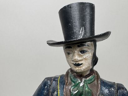 Polychrome cast-iron clock depicting a peddler.
H....