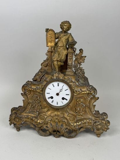 A pendulum clock with a golden patina, depicting...