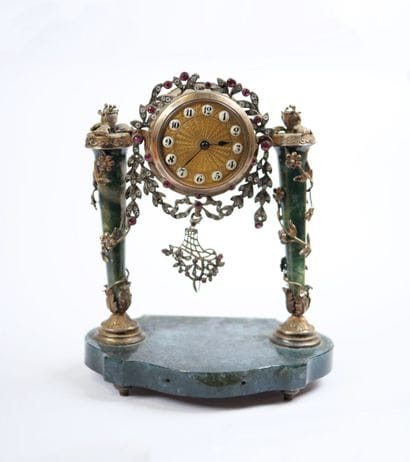 A column-style table clock with scalloped...