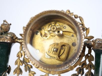 A column-style table clock with scalloped...