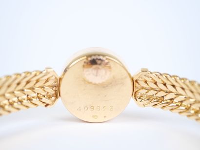 OMEGA. 
Ladies' watch with a round case and...
