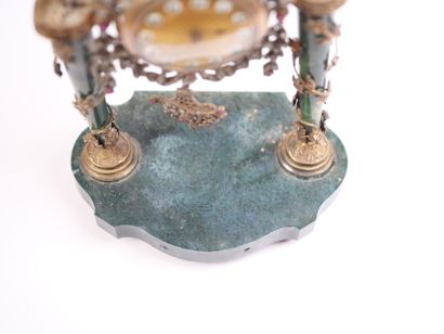 A column-style table clock with scalloped...