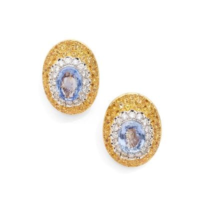 A striking pair of oval ear clips in 18K...