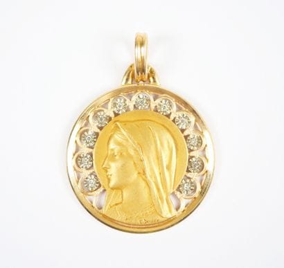 A circular religious medal in 18K (750‰)...