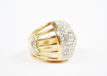 A large openwork dome ring in 18K yellow...