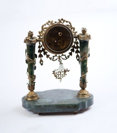 A column-style table clock with scalloped...