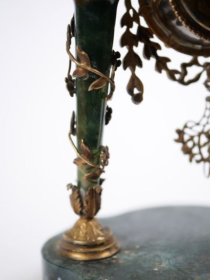 A column-style table clock with scalloped...