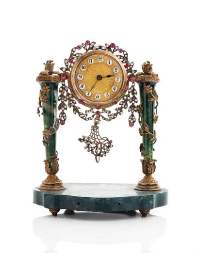 A column-style table clock with scalloped...