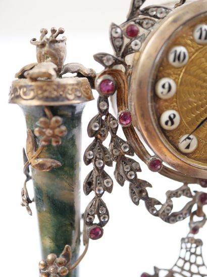 A column-style table clock with scalloped...