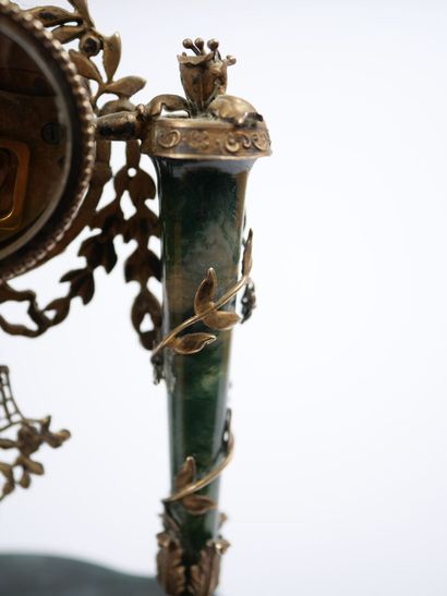A column-style table clock with scalloped...