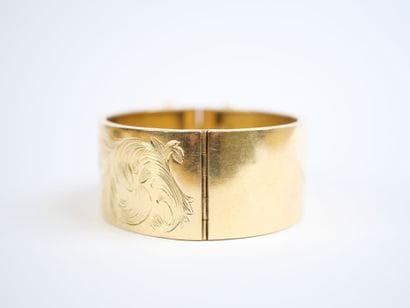 Wide, hinged bracelet in 18K yellow gold...