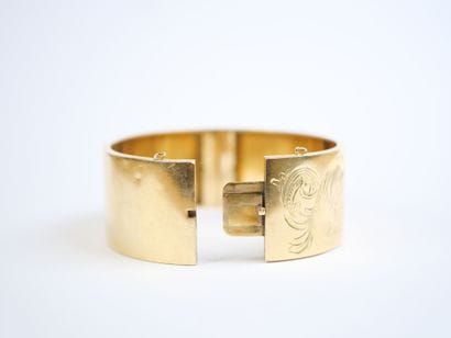Wide, hinged bracelet in 18K yellow gold...