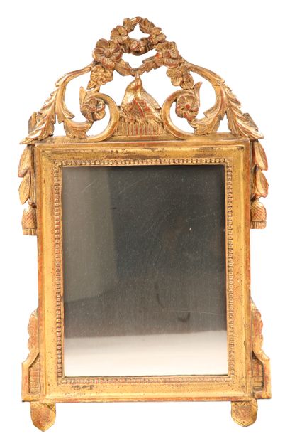 Wood and gilded stucco pediment mirror decorated...
