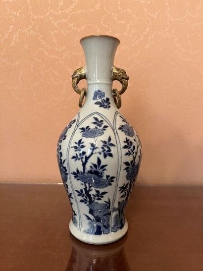 CHINA.
Porcelain bottle vase with cameo decoration...