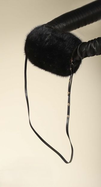 * LOUIS VUITTON.
Manchon en vison noir, lanière...