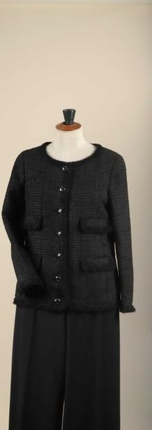 * CHANEL.
Veste en tweed noir à fond de paillettes...