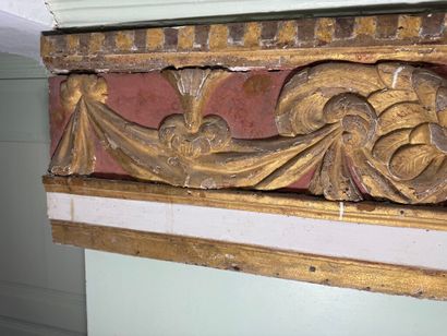 Carved wood paneling with ochre and white...