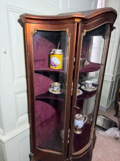 A veneered wood display case, decorated in...