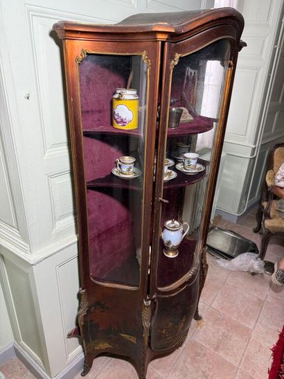 A veneered wood display case, decorated in...
