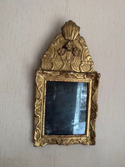 Small pediment mirror in carved and gilded...