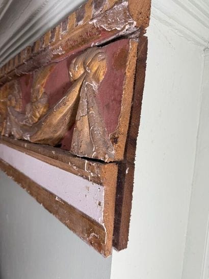 Carved wood paneling with ochre and white...