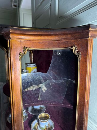 A veneered wood display case, decorated in...