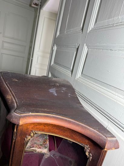 A veneered wood display case, decorated in...